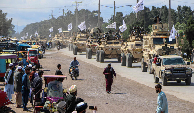 Taliban fighters in armoured vehicles take part in a military street parade in Herat on April 19, 2022. (AFP)