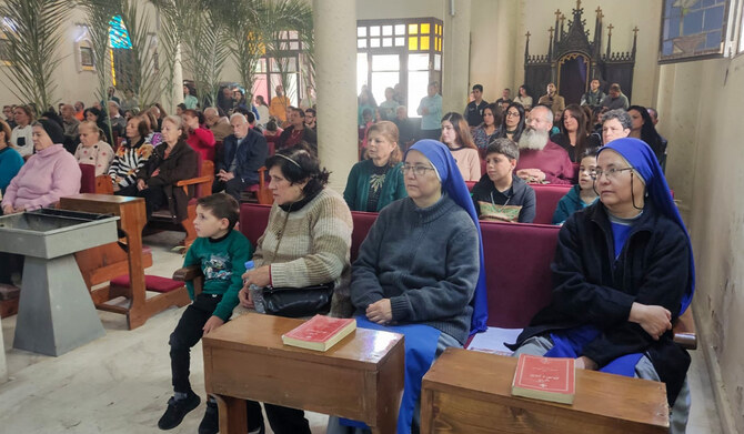 Palestinian Christians gather at the Roman Caltholic church of the Holy Family on Palm Sunday in Gaza City. (AFP)