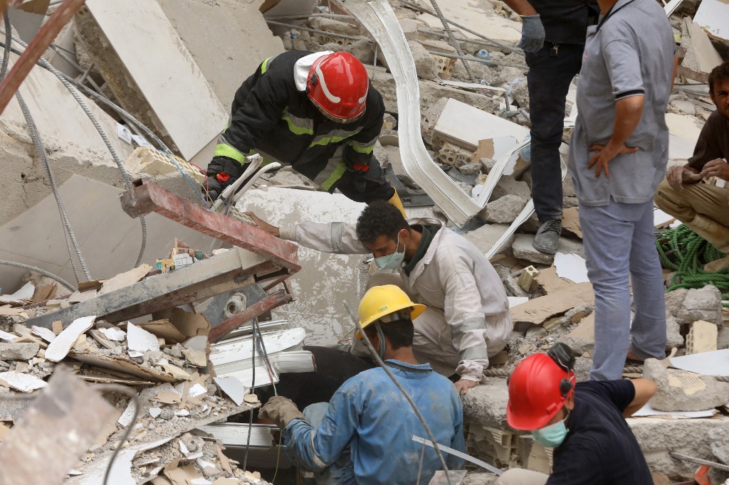 More than four days after the tower block’s collapse, rescue teams were recovering bodies from under slabs of cement. (AFP)